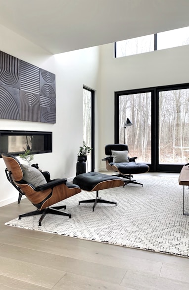 black leather padded armchair near black wooden framed glass window