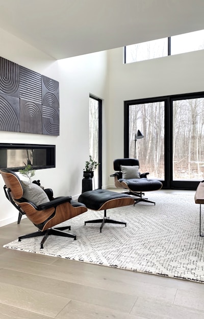 black leather padded armchair near black wooden framed glass window