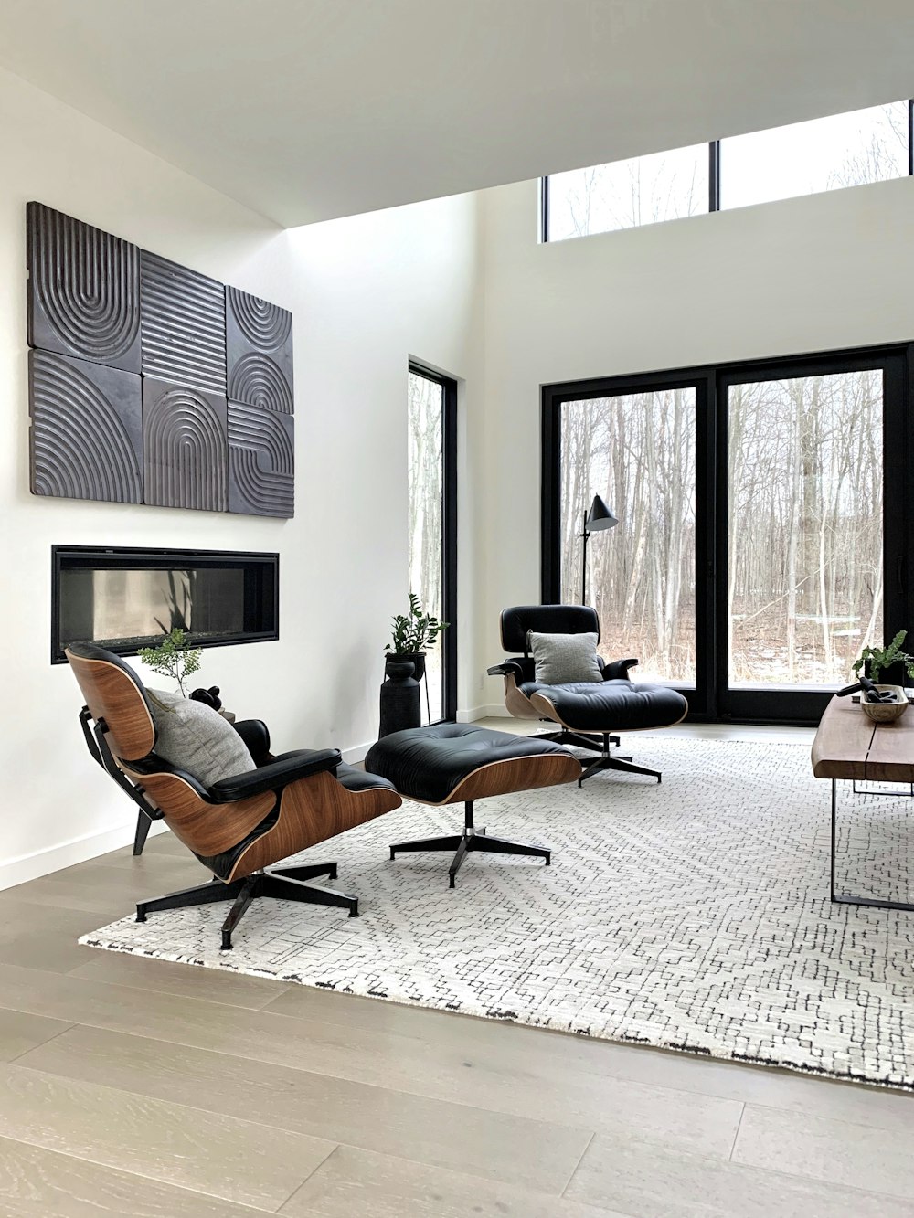 black leather padded armchair near black wooden framed glass window