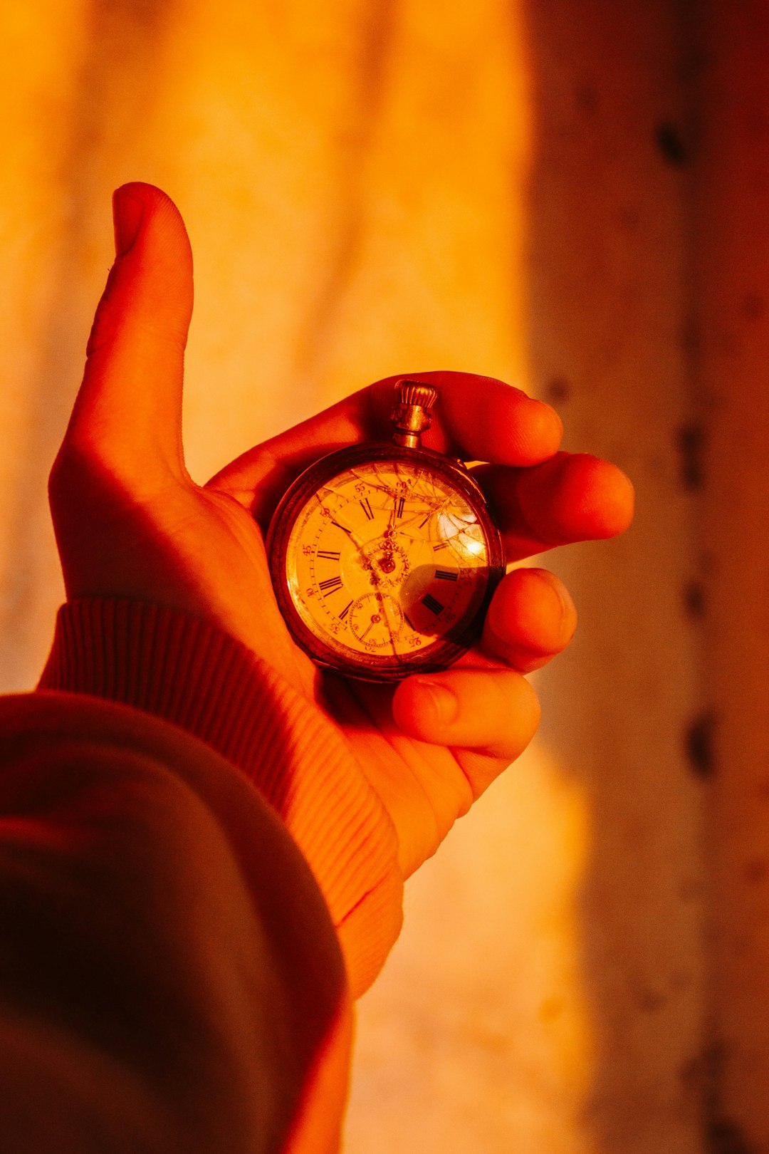 person holding silver and black chronograph watch