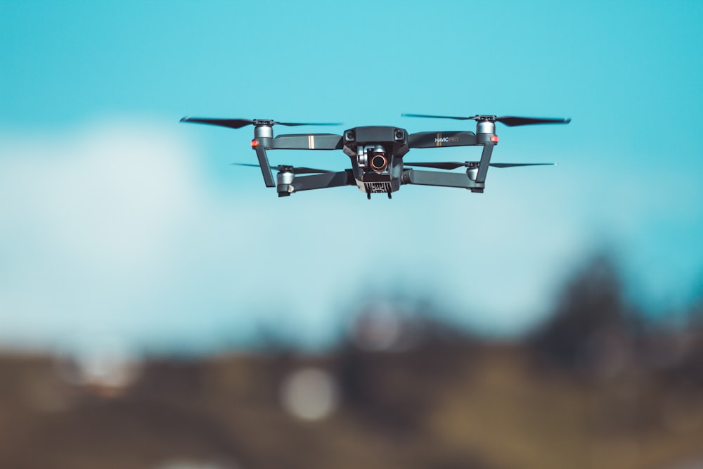 red and black drone in mid air