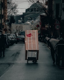 red and white box on road during daytime