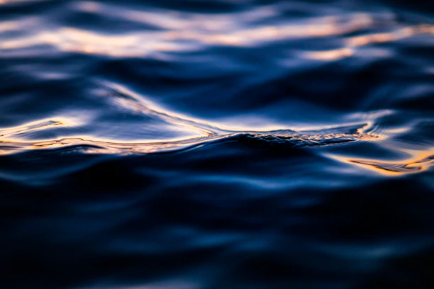 Close-up of deep blue water textures with light ripples and subtle reflections.
