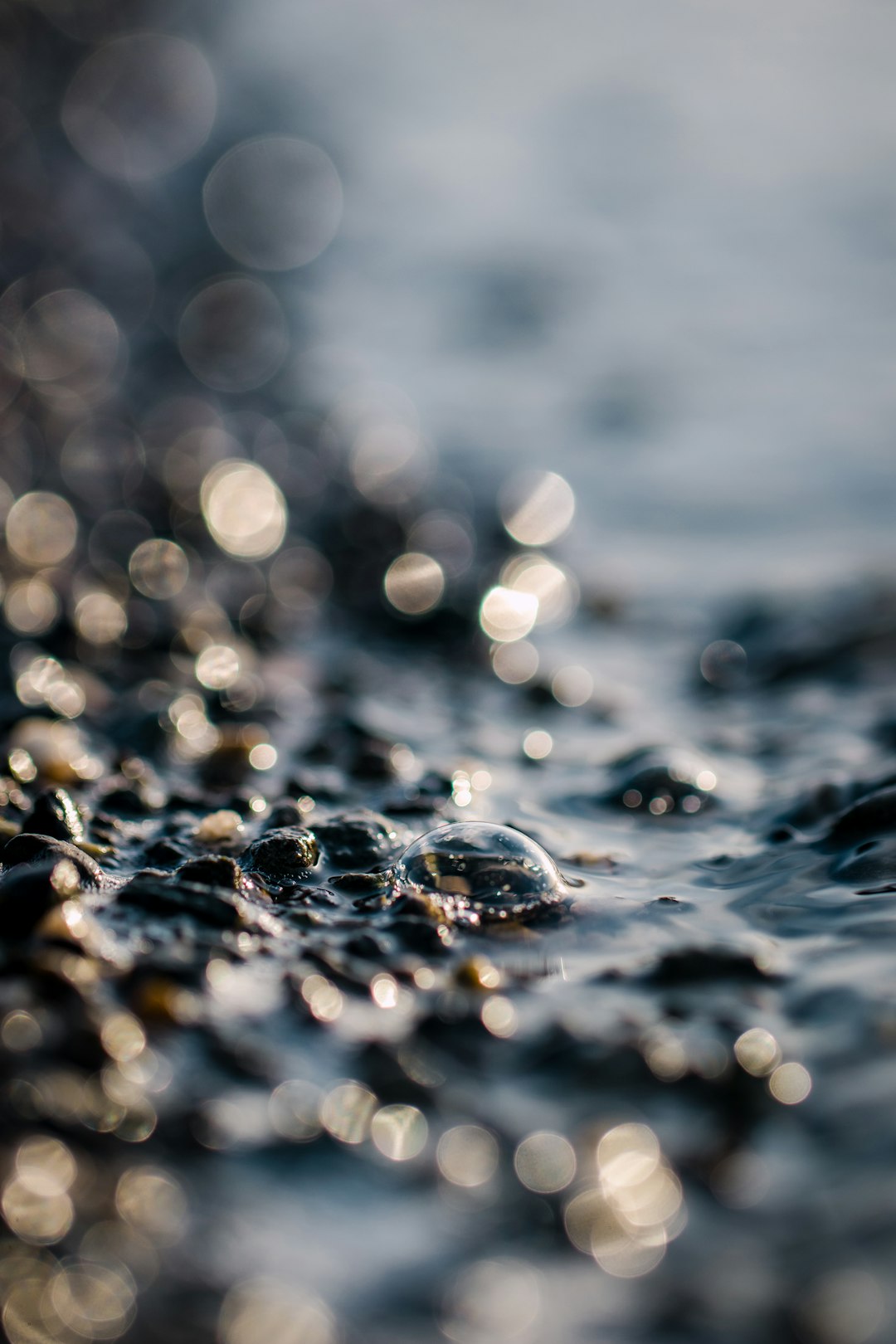 water droplets on body of water during daytime