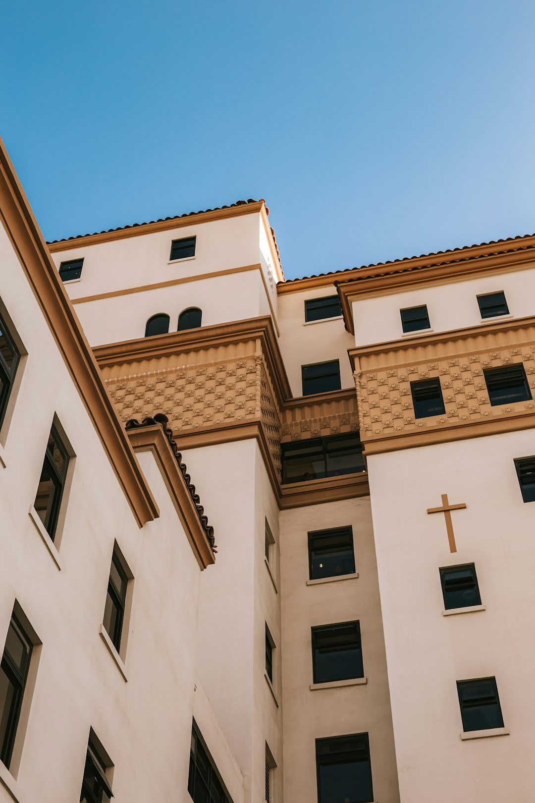 brown and white concrete building under blue sky during daytime