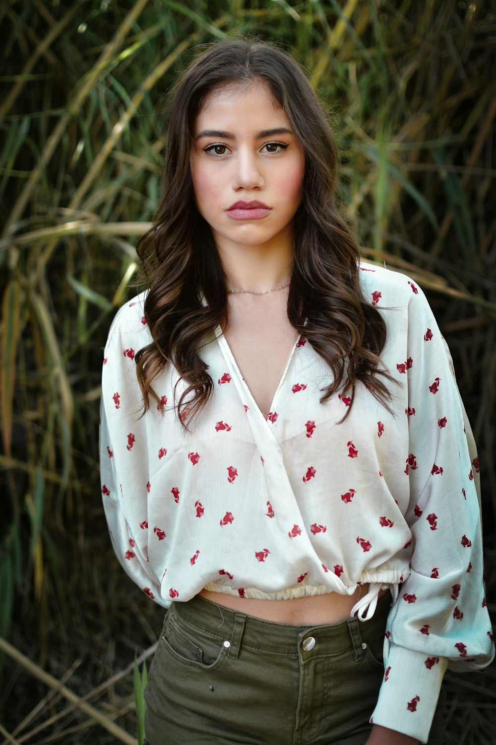 woman in white red and black floral button up long sleeve shirt