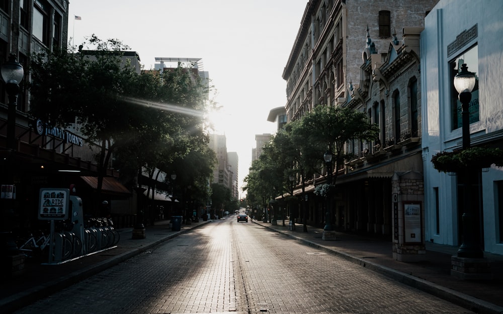 people walking on sidewalk between buildings during daytime