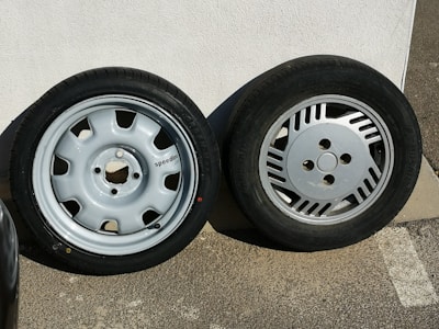 Shiny new rims displayed on a sleek white wall with light green branding.