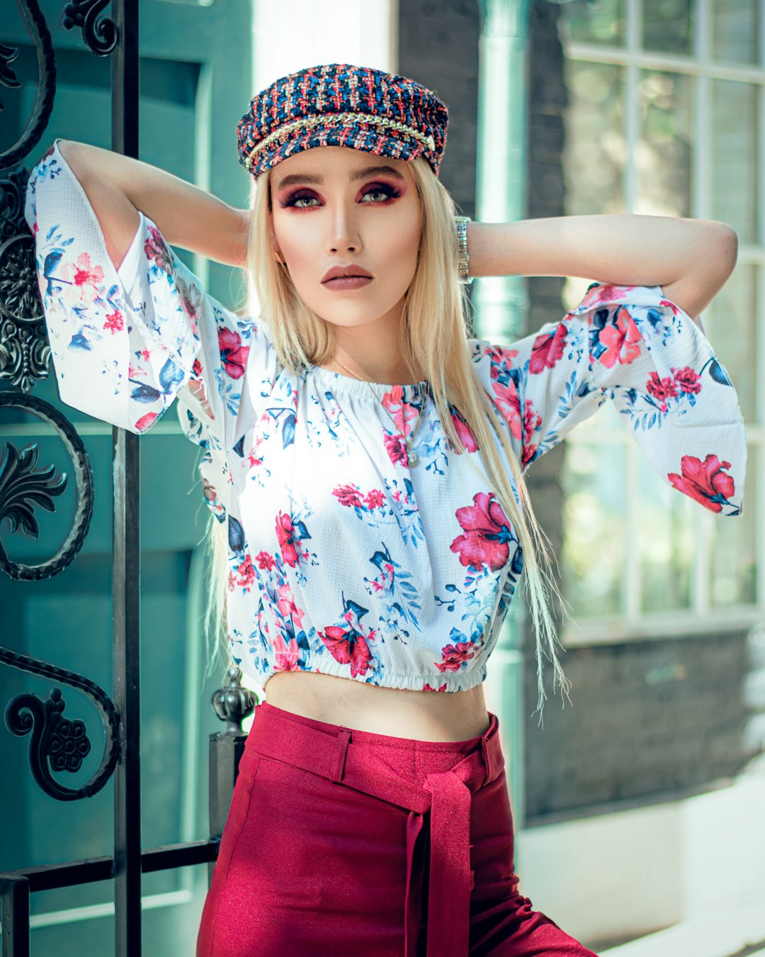 woman in white and red floral shirt and red skirt