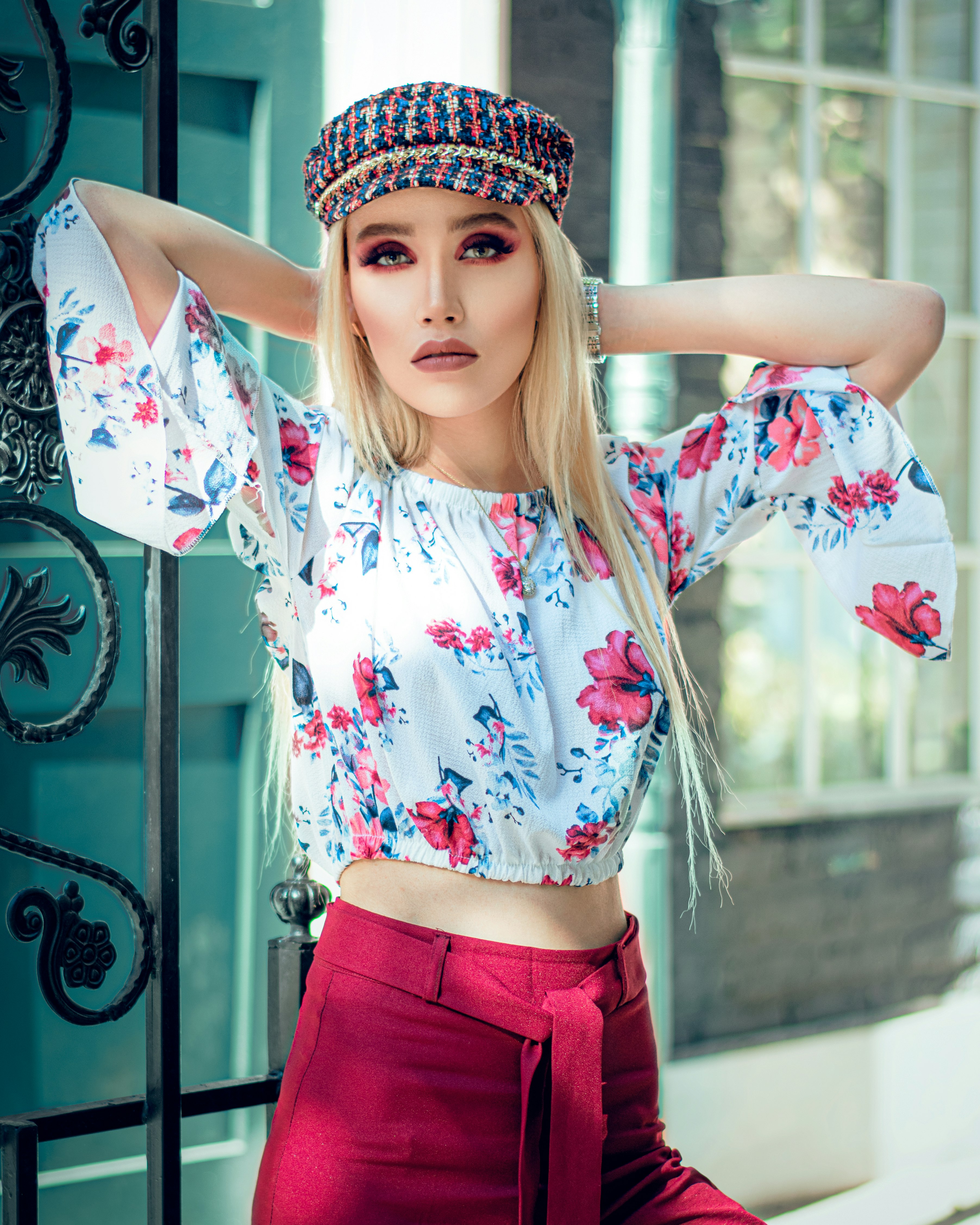 woman in white and red floral shirt and red skirt