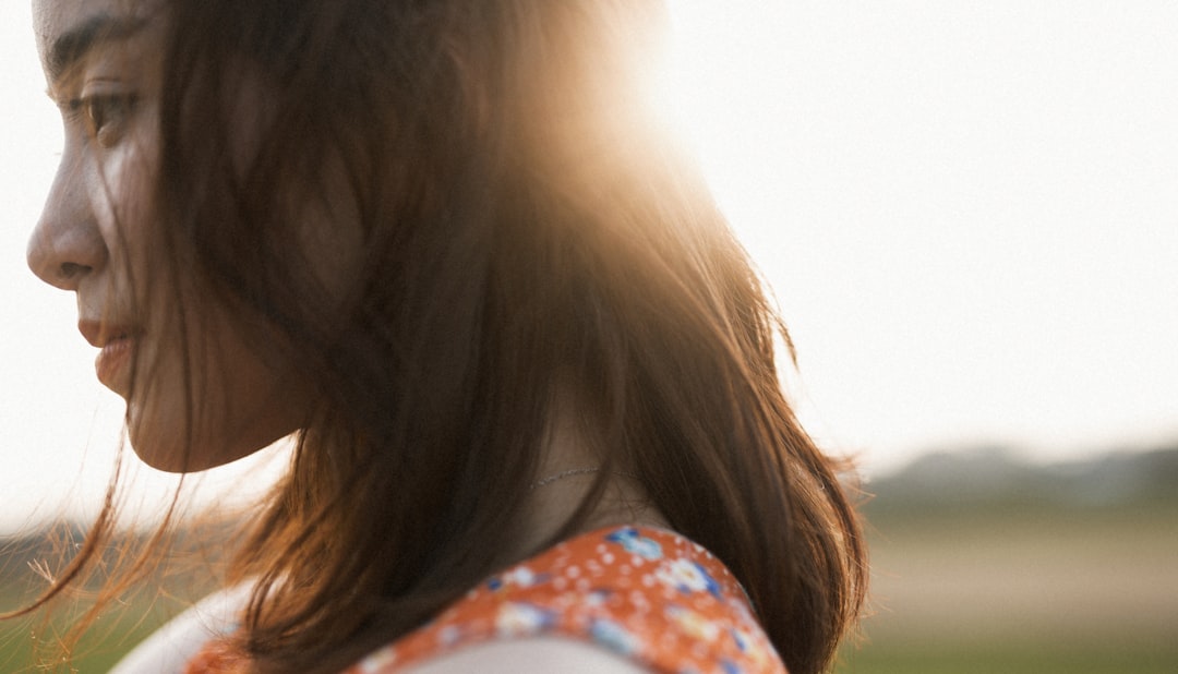 woman in white blue and red floral shirt