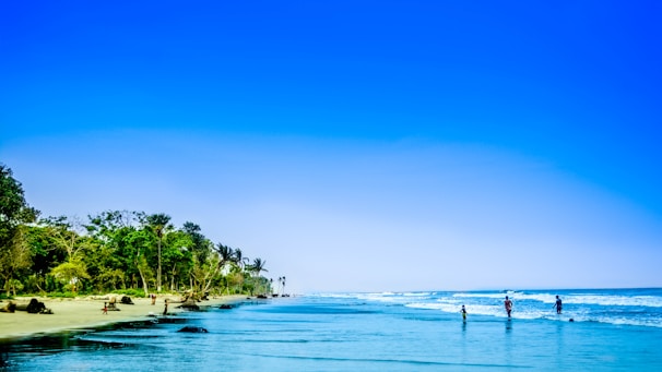 A serene beach scene with people enjoying water activities.