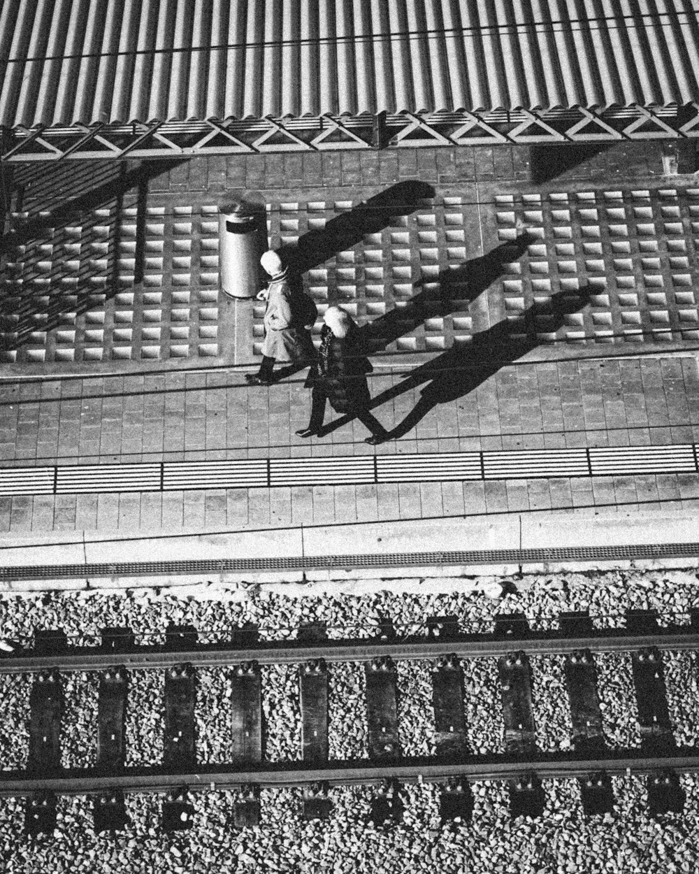 man in black jacket and pants jumping on black metal fence