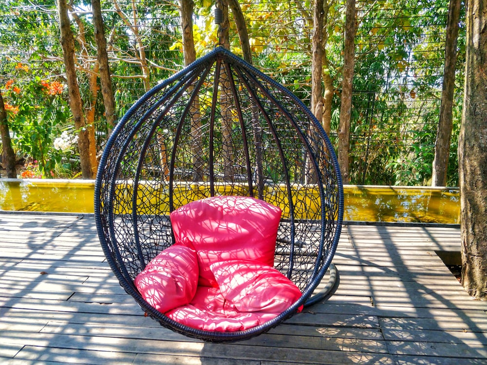 red and white floral hammock on brown wooden floor