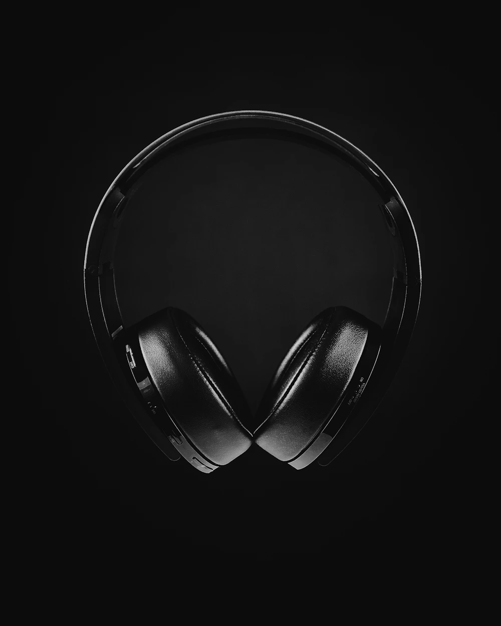 Black over-ear headphones in monochrome lighting