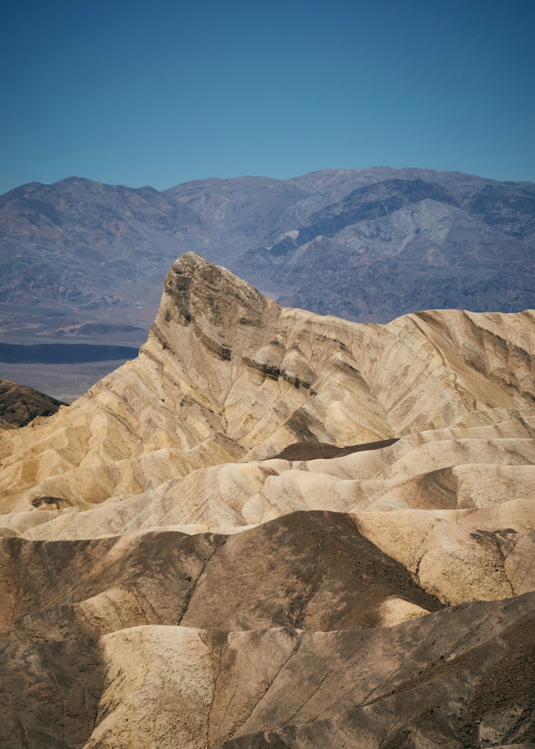 brown rocky mountain near body of water during daytime