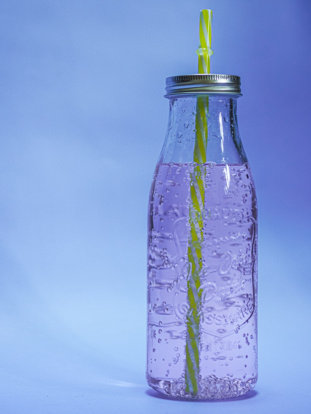 clear glass bottle with water