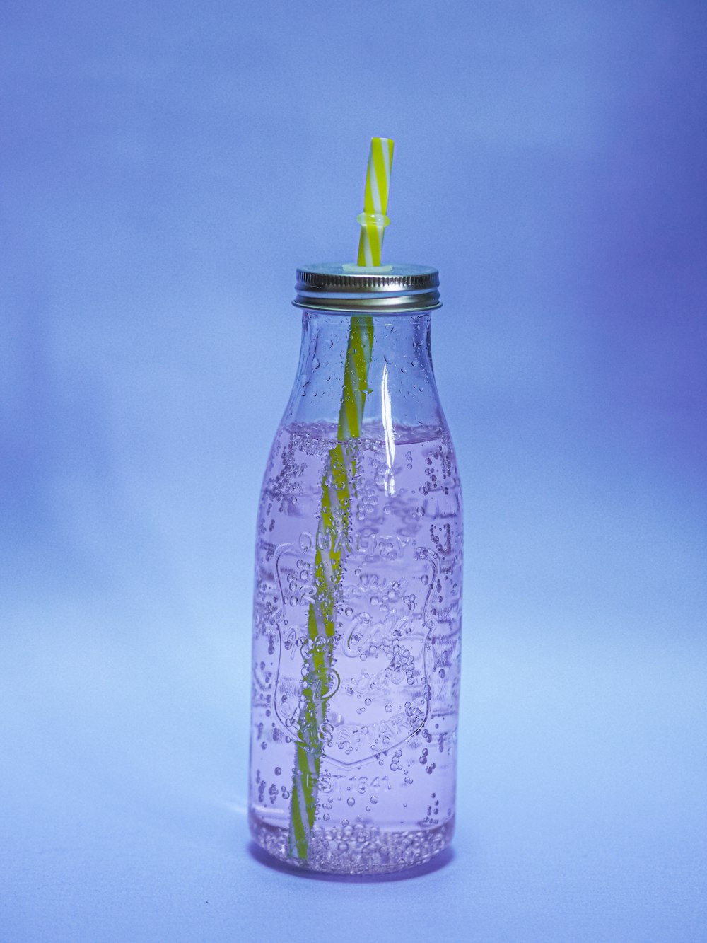 white and green floral glass bottle