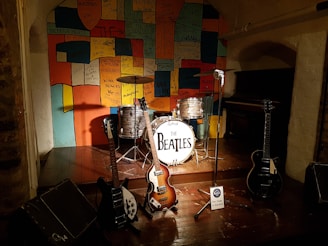 brown and white electric guitar on brown wooden floor