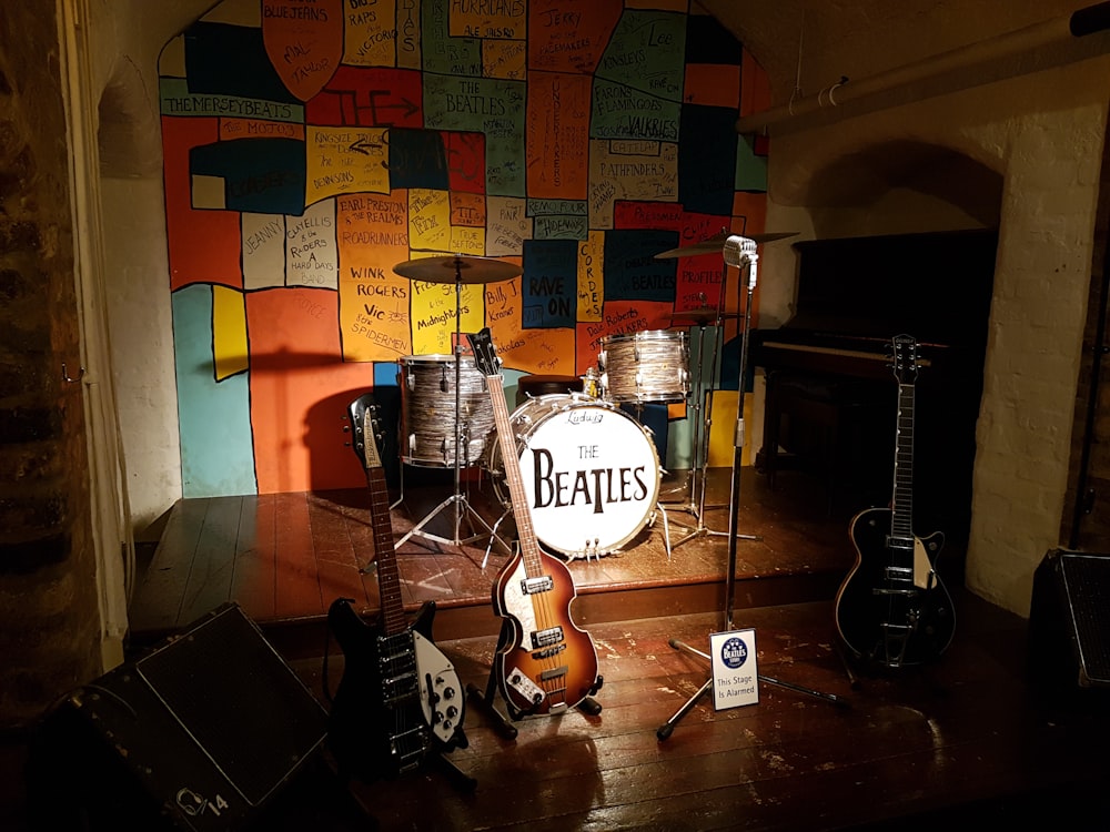 brown and white electric guitar on brown wooden floor