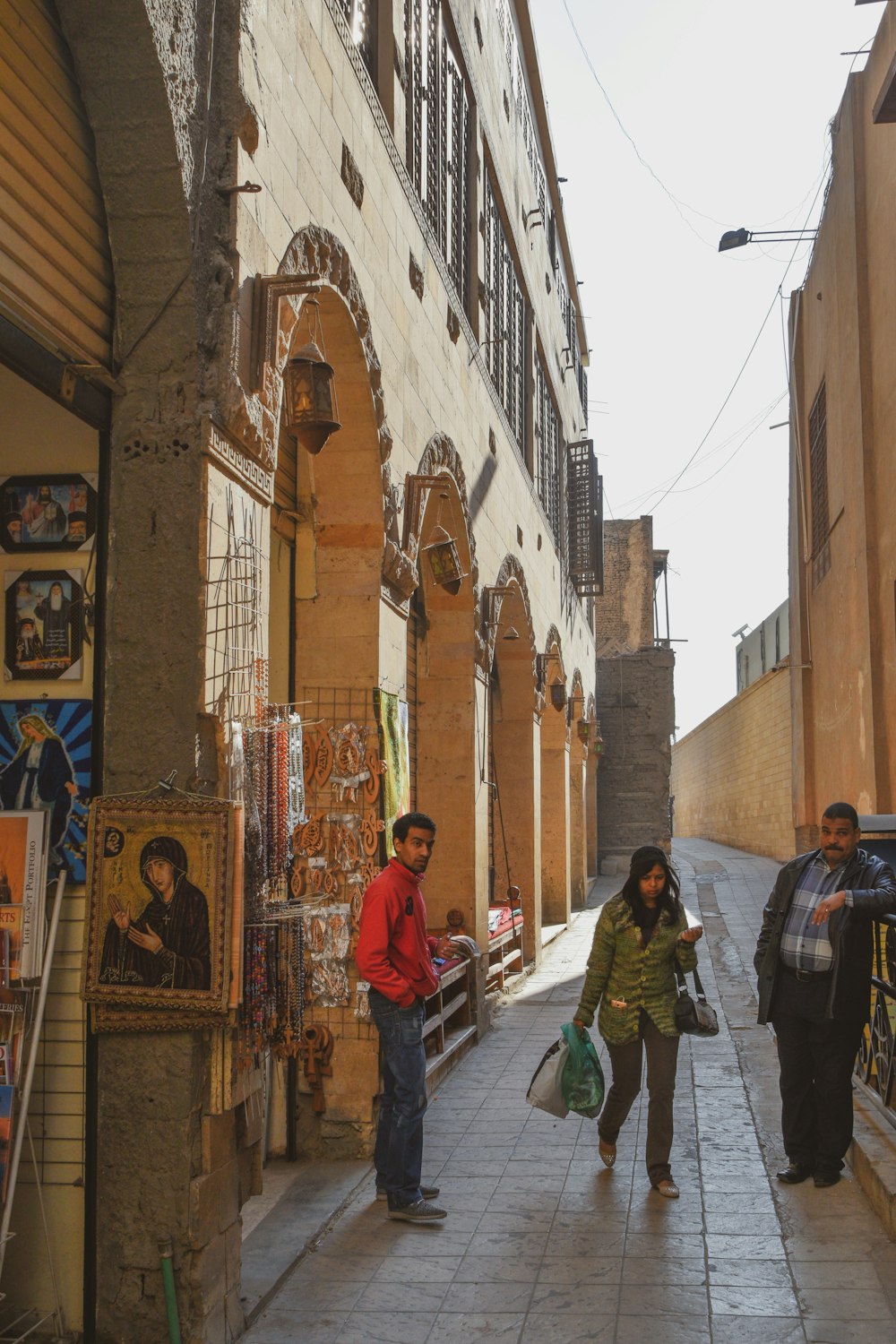 people walking on street between buildings during daytime