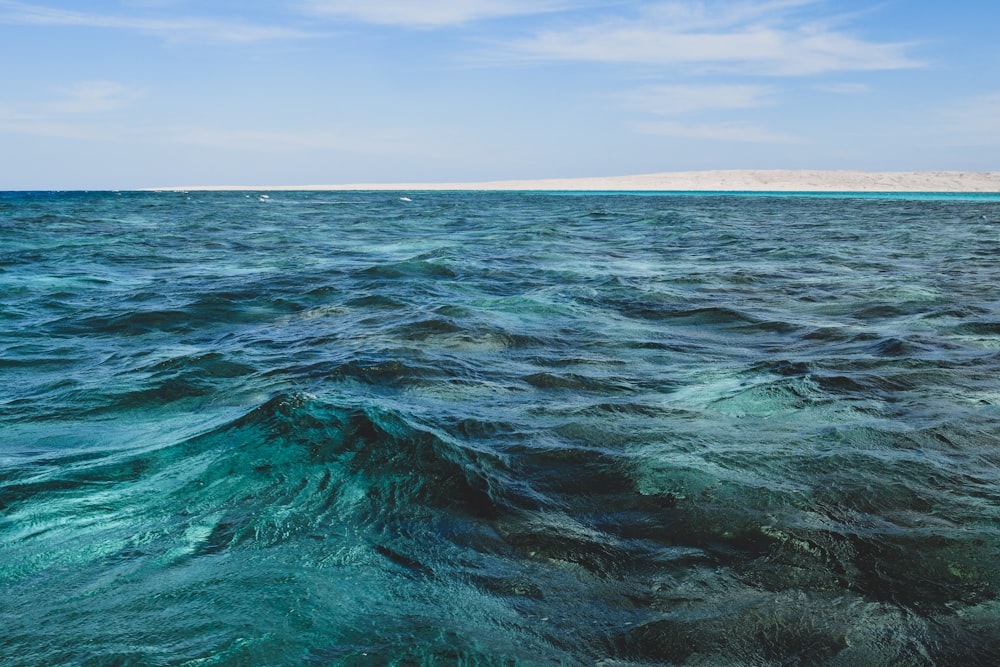 blue ocean water under blue sky during daytime