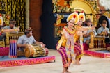 Tourists enjoying a traditional Balinese dance.