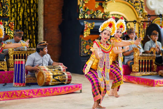Traditional Balinese dance performance by students in colorful costumes at the school courtyard.