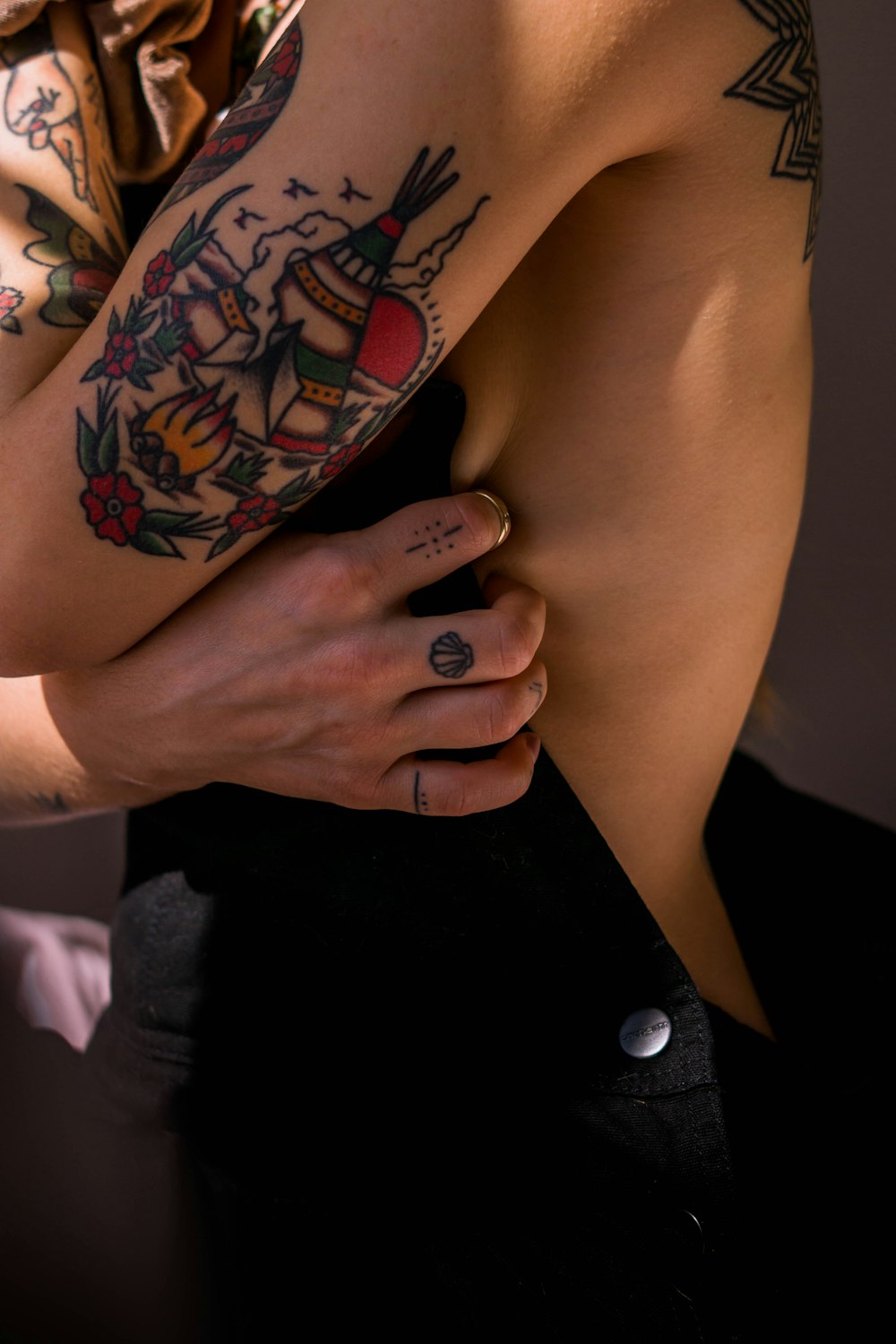 woman in black dress with red rose tattoo on her left hand