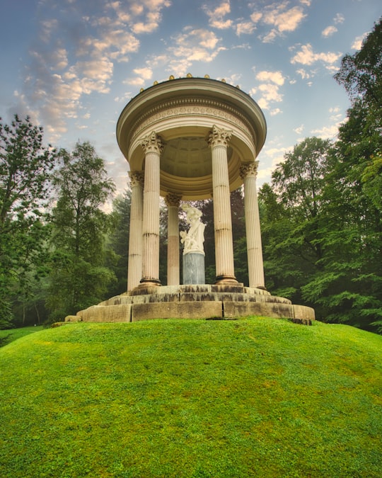 white concrete statue on green grass field during daytime in Linderhof Palace Germany