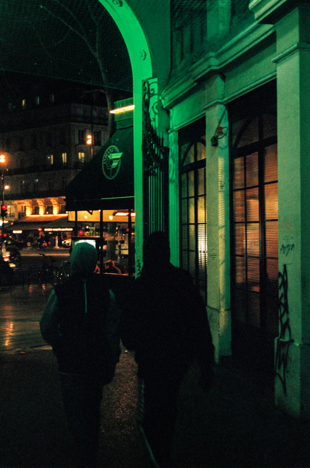 people walking on sidewalk during night time