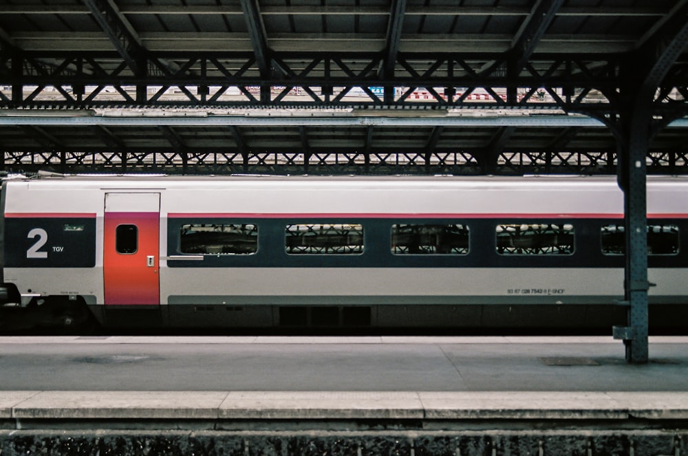 white and red train on train station