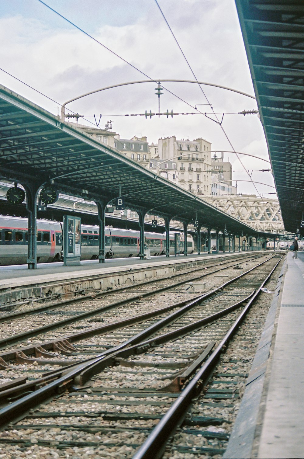 train rail near city buildings during daytime