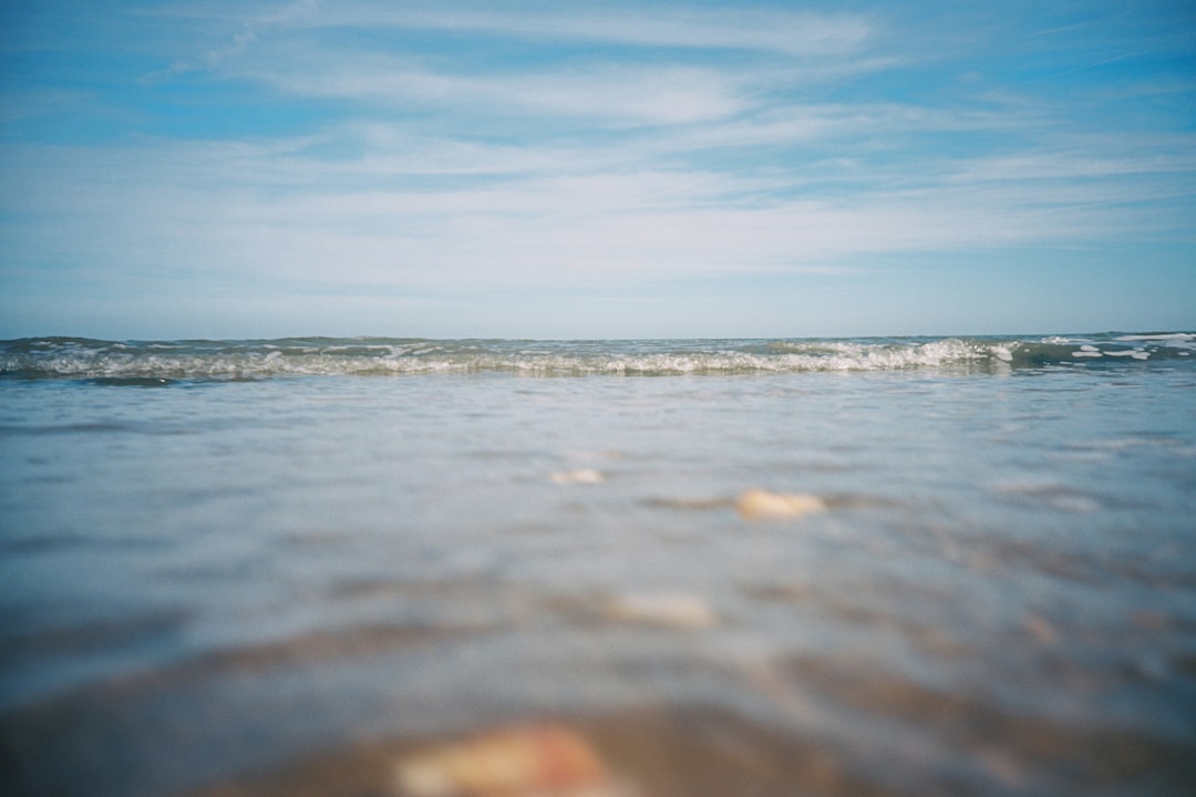 ocean waves under blue sky during daytime