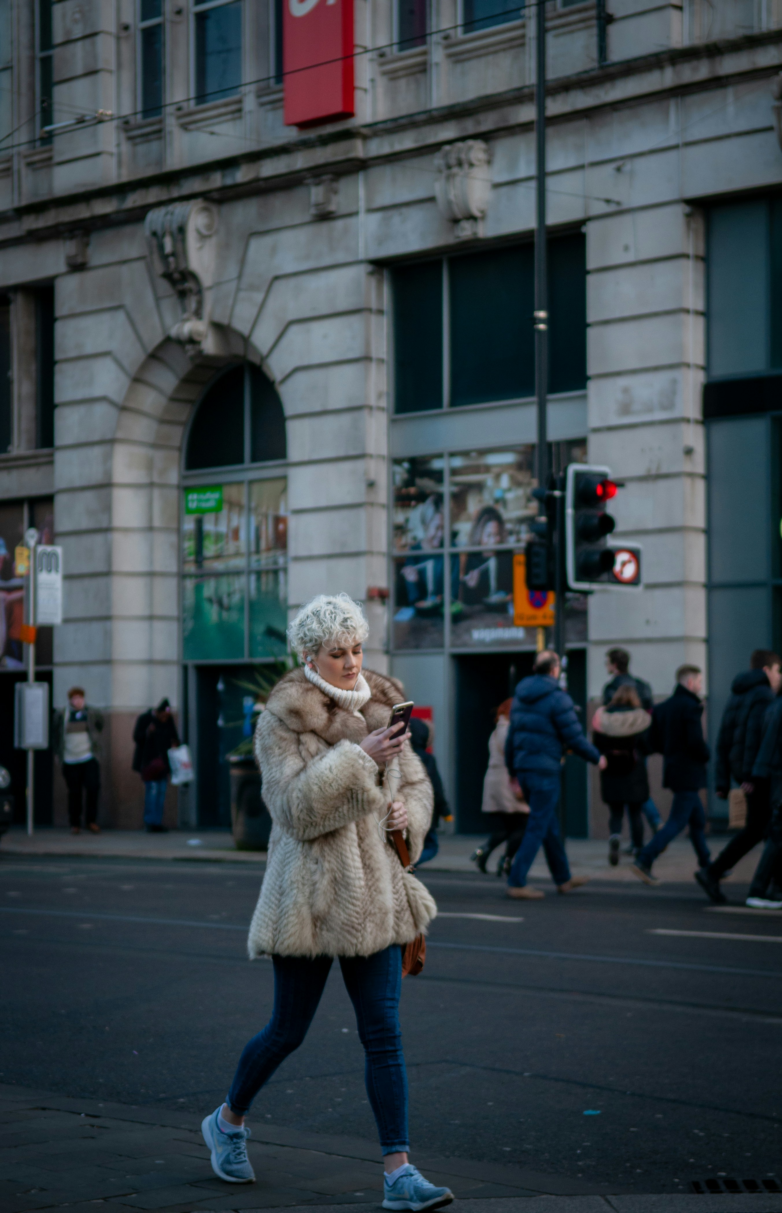 Woman in brown fur coat standing on sidewalk during daytime photo ...