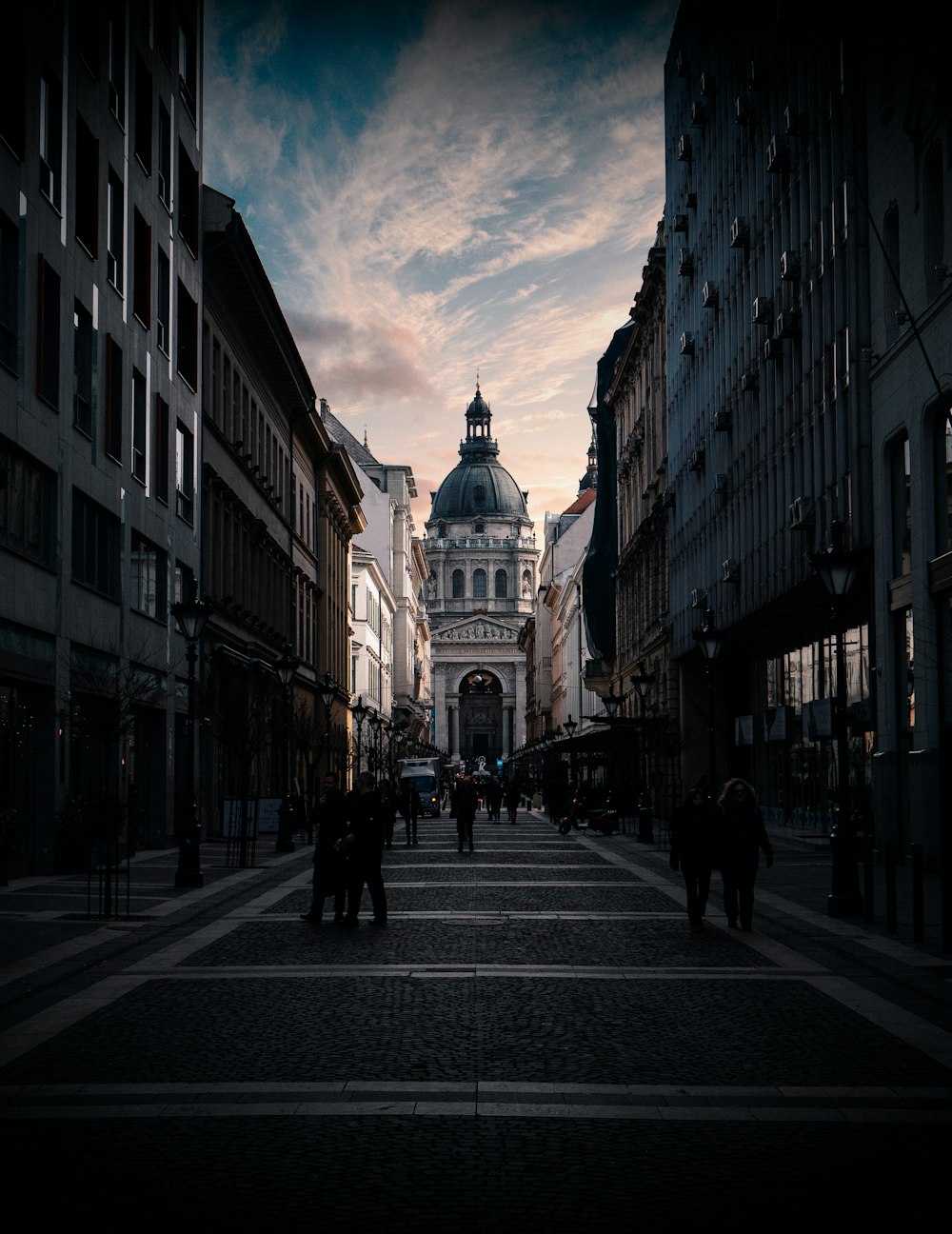 people walking on street between buildings during daytime