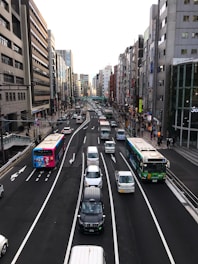 A busy city street with various vehicles transporting people and goods.