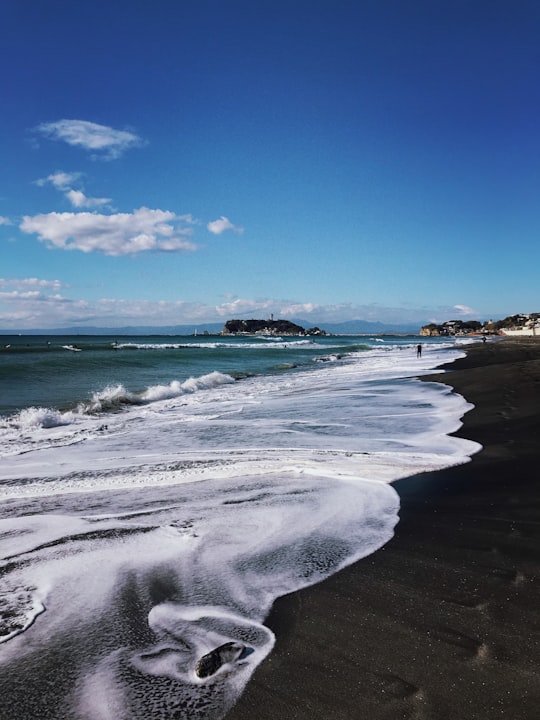 white sand beach during daytime in Kamakura Japan