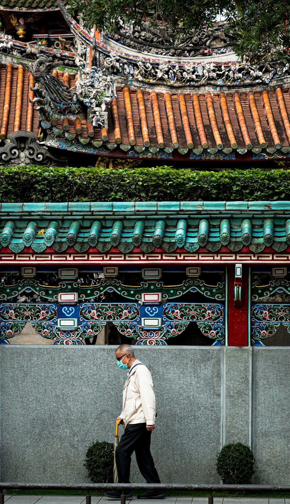 man in white long sleeve shirt sitting on gray concrete stairs