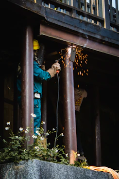 man in blue jacket and blue pants holding rope