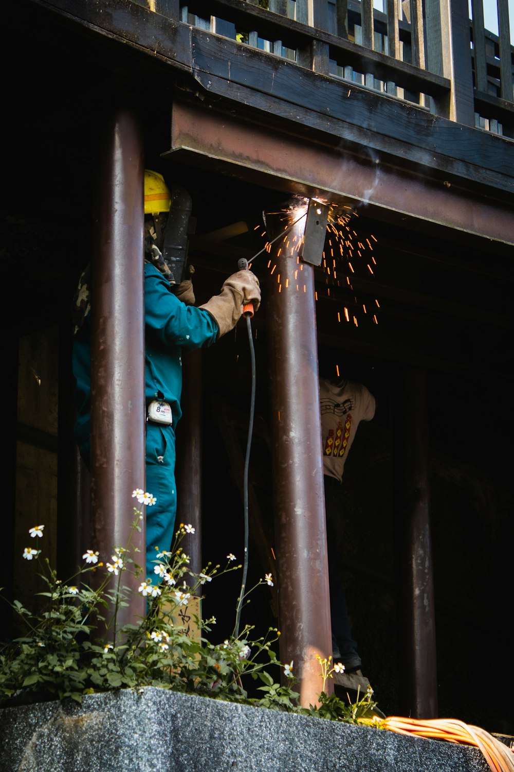 man in blue jacket and blue pants holding rope