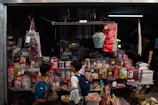 An inviting scene of a cozy shop corner with shelves filled with various imported goods from Japan and Korea.