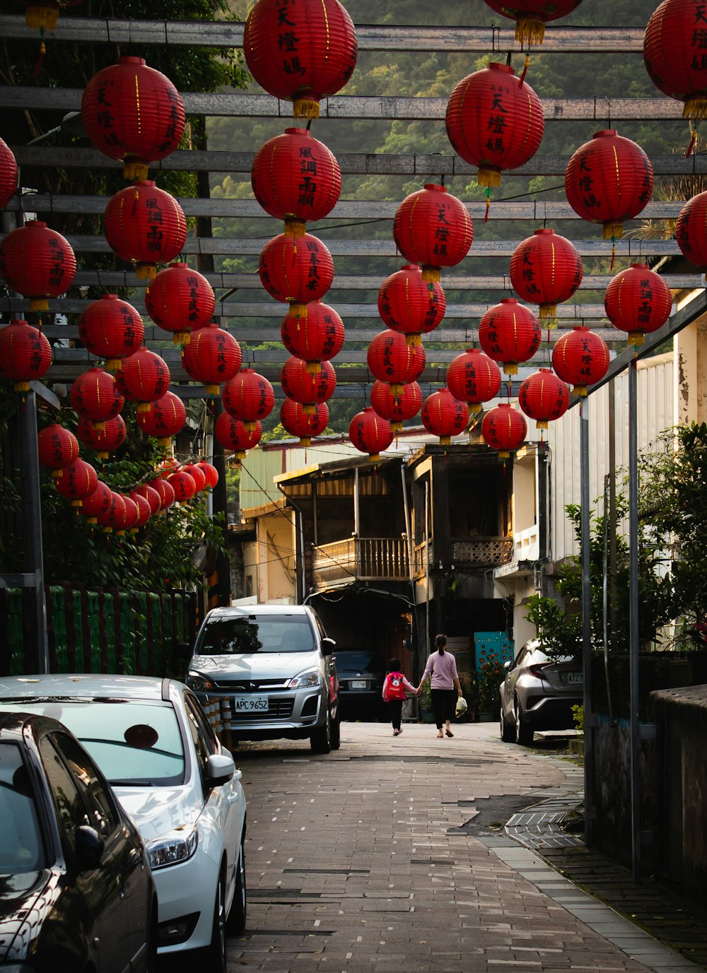 red round balloons on street during daytime