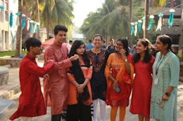 group of people standing near green trees during daytime