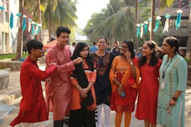 group of people standing near green trees during daytime