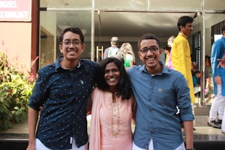 A group portrait of doctors representing allopathy, homeopathy, and Ayurveda standing together with warm smiles.