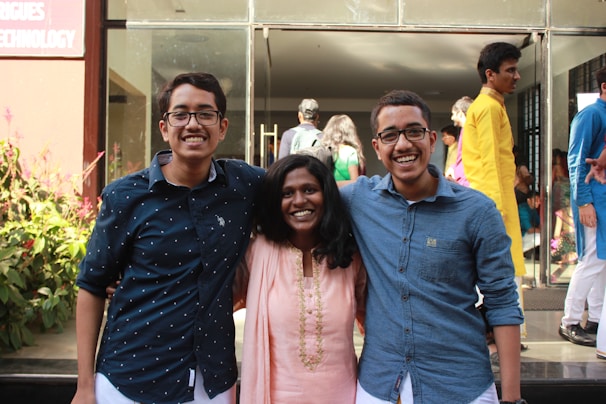 A group portrait of doctors representing allopathy, homeopathy, and Ayurveda standing together with warm smiles.