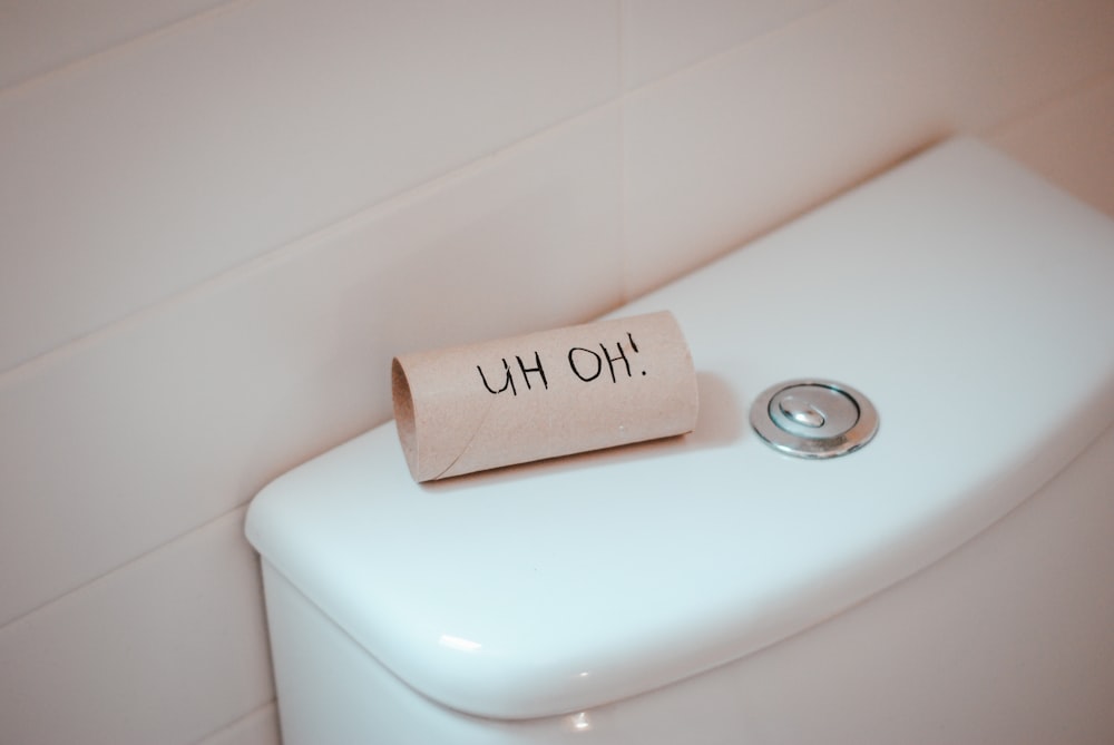 a roll of toilet paper sitting on top of a toilet