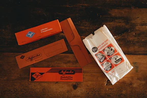 white and orange plastic pack on brown wooden table