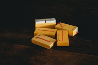Various packaging boxes and materials arranged on a wooden table.
